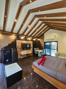 a bedroom with a large bed and a living room at Aamara in Bangalore