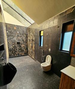 a bathroom with a sink and a toilet in it at Aamara in Bengaluru