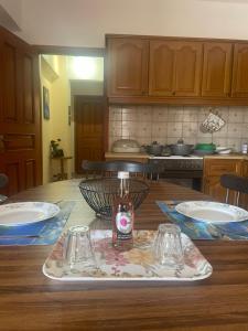 a table with a tray with a bottle and two glasses at Ionian Escape in Agia Effimia +12 photos