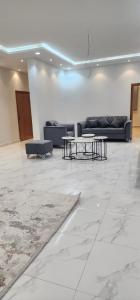 a lobby with couches and tables in a room at فيلا بحوش خاص in Al Baha