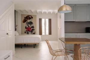 a living room with a bed and a painting of a woman at Next Level Apartments in Villajoyosa
