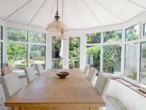 a dining room with a wooden table and chairs at Barn Cottage in Wick