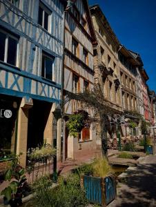 a group of buildings with plants in front of them at Chambres d'hôtes La Tribu in Quévreville-la-Poterie