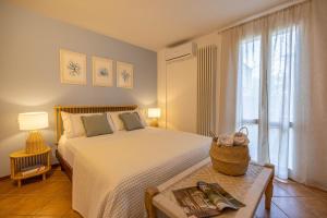 a bedroom with a large bed and a window at Casa Orizzonte - Appartamento con vista in Gabicce Mare
