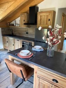 a kitchen with a table with plates and flowers on it at Méijòn Lo Brenlo in Courmayeur