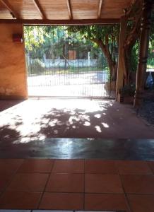 a shady patio with a fence and a tree at Marcelo Buja in Jardín América +7 photos