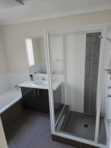 a bathroom with a shower and a sink and a mirror at Seaviews in Lancelin +16 photos