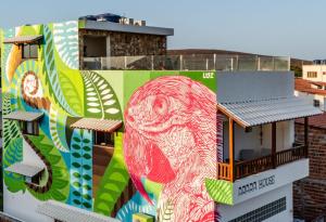 a building with a mural on the side of it at Arara house 1 in Jericoacoara