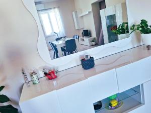 a white bathroom with a mirror and a dining room at Casa Dolce Casa in Termoli +25 photos