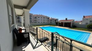 a swimming pool on the balcony of a house at RIVABeach House in Lourinhã