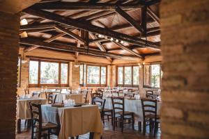 a dining room with tables and chairs in a building at Donnastella in Guardavalle