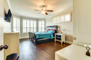 HelotesGroup Getaway with Home Theater in San Antonio!的带床和吊扇的卧室