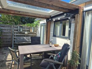 a table and chairs on the patio of a trailer at Chalet op de veluwe in Putten