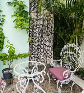 a patio with a table and chairs and plants at The Quetzal in Cancún
