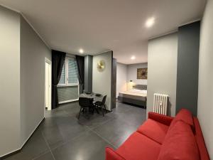 a living room with a red couch and a bedroom at ANGELICA Luxury in Bologna