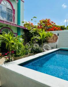 a swimming pool in front of a building at The Quetzal in Cancún