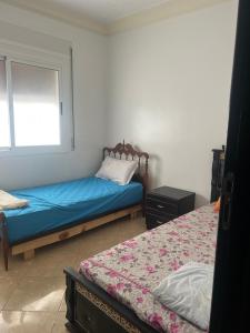 a bedroom with two beds and a window at Irmis in Oued Laou