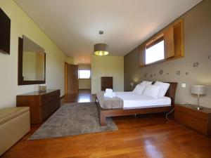 a large bedroom with a bed and a living room at Tasteful Braga Villa 4 Bedrooms Villa Helena Private Pool & Close To Amenities Esposende in Esposende +23 photos