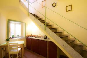 a staircase in a kitchen with a table and a sink at Charming Rooftop Flat in City Center in Catania