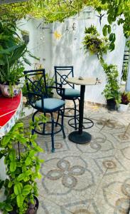 a patio with two chairs and a table and some plants at The Quetzal in Cancún
