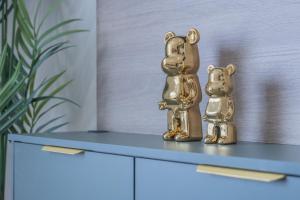 zwei goldene Hundestatuen, die auf einer Kommode sitzen in der Unterkunft Unit 3 Spacious & Ideal 1-BR Stays, Near Sheffield United Football Club, Wifi-Parking & Comfortable in Sheffield