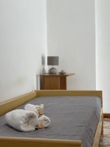 a bedroom with a bed with towels on it at Da Fede al mare in Moneglia