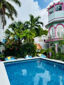 a swimming pool in front of a building at The Quetzal in Cancún