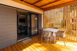 a dining room with a table and chairs on a balcony at Diana & Josip Mobile Homes in Biograd na Moru