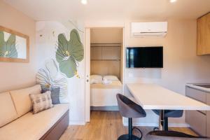 a kitchen and living room with a couch and a table at Diana & Josip Mobile Homes in Biograd na Moru
