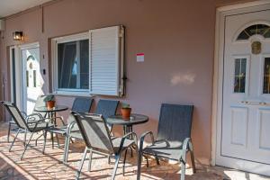 a group of chairs and tables on a patio at Perdika center rooms in Pérdika