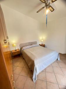ein Schlafzimmer mit einem Bett und einem Deckenventilator in der Unterkunft La Casa In Piazza in Marina di Camerota + 21 Fotos