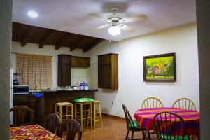 a kitchen and dining room with two tables and chairs at Casa de huéspedes la guarecita in Pátzcuaro
