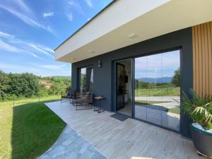 a patio with glass doors and a table and chairs at LaLuna Houses in Lipova