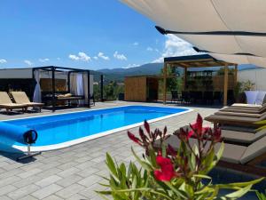 a swimming pool with a patio and a house at LaLuna Houses in Lipova