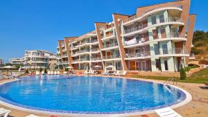 ein großes Schwimmbad vor einem Gebäude in der Unterkunft Sunset Complex Кошарица Апартамент 15 in Kosharitsa