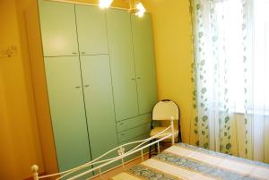 a bedroom with a green cabinet and a mirror at Villa Lussu in Orosei