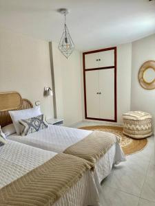 a large bedroom with two beds and a door at Apartamentos Sarga Sentirgalicia in Cabañas +67 photos