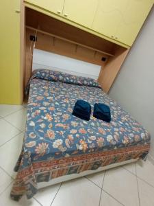 a bed with two bags sitting on top of it at Verti House appartamento, Frignano in Frignano