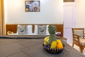 a bowl of fruit on a table in a bedroom at DUSK VIBES near mall roade kasauli Entire 1-bedroom with private balcony with delicious food in Kasauli
