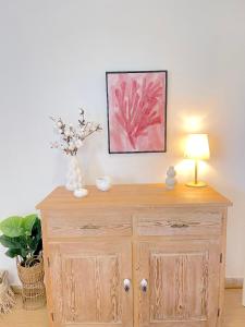 a wooden dresser with a lamp and flowers on it at Lemon Tree House, Golden Beach in Chrissi Akti +21 photos
