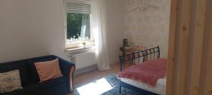 a bedroom with a bed and a window and a chair at Aasee Apartments in Münster