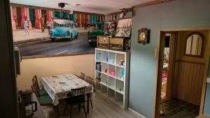 a dining room with a table and a car on a street at Kiinteistö Hetekka in Kouvola +7 photos