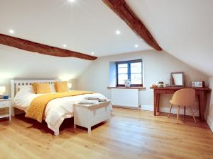 a bedroom with a bed and a desk and a window at 3 Bed in Niton 93697 in Niton