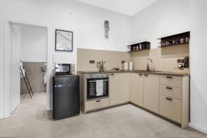 a kitchen with a stove and a refrigerator at Loft im Herzen von Paderborn in Paderborn +16 photos
