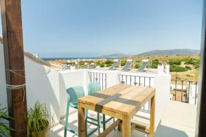 a balcony with a table and chairs and the ocean at Tarifa Cozy House - Casa Verde Agua in Tarifa