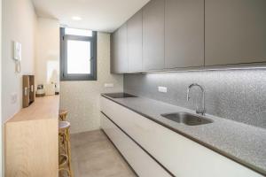 a kitchen with a sink and a counter at Tarifa Cozy House - Casa Verde Agua in Tarifa