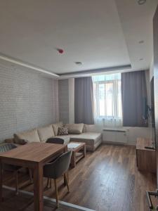 a living room with a couch and a table at President kop apartment 412 in Kopaonik