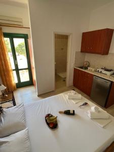 a large white bed in a kitchen with fruit on it at Santa Magia in Kamari