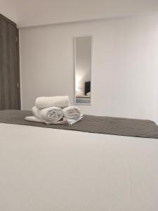 a pile of towels sitting on top of a bed at LUX Central in Alexandroupoli +100 photos