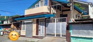 a house with a smiley face painted on the street at Check & Travel in Olongapo
